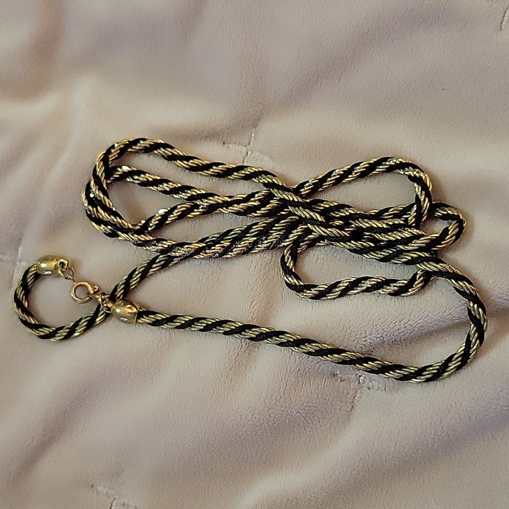 A vintage Trifari gold and black tone necklace